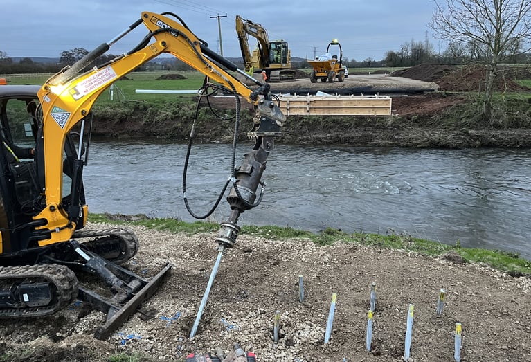 Chance helical piles being installed for a bridge foundation